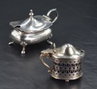 Two early 20th century silver mustard pots, the larger of roudned and compressed rectangular form