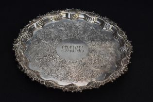 A George V silver salver, of circular form with gadrooned, C-scroll and shell ornamented rim