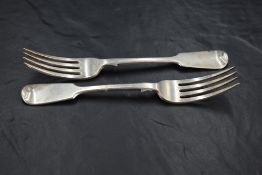 A pair of Victorian provincial silver fiddle pattern forks, with Hanoverian terminals, marks for