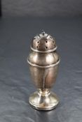 A George V silver sugar caster, of elongated urn form with finial topped and pierced pull-off