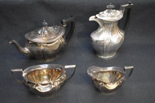 An Edwardian Art Nouveau silver four-piece tea set, comprising teapot, coffee pot with strainer bag,