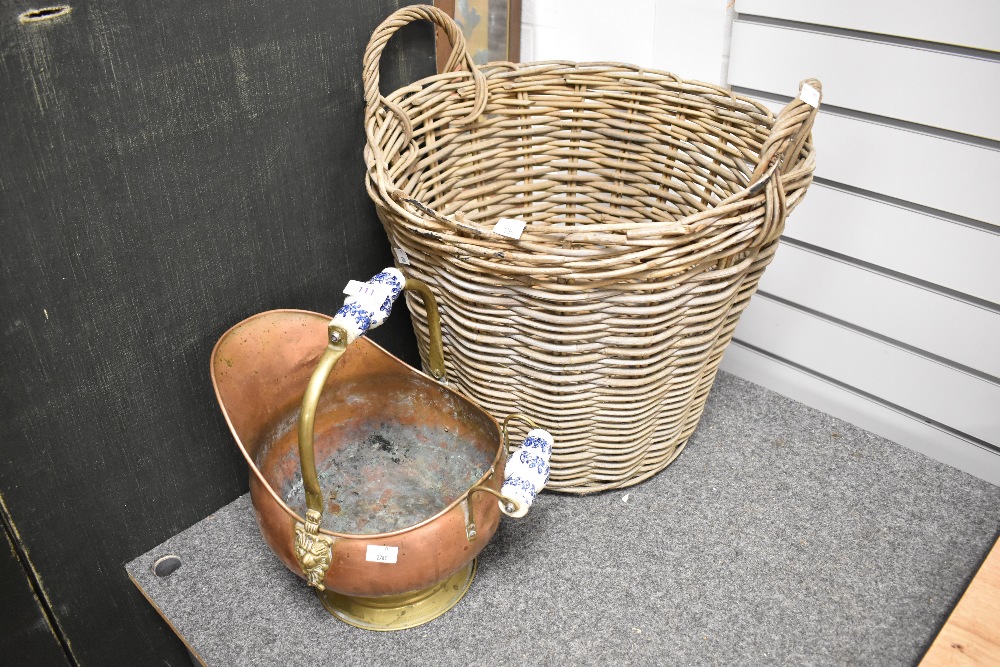 A wicker log basket and a copper fire helmet with ceramic handles.