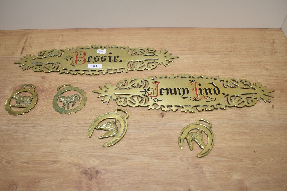 Two brass name plaques, 'Bessie' and 'Jennie Hind' and four horse brasses.