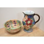 A Royal Doulton wild rose patterned jug and a Royal Doulton bowl with floral design on peach