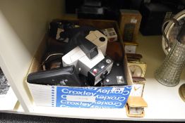 A collection of vintage cameras, including Poloroid Swinger model 20 and Kodak Brownie 127, sold