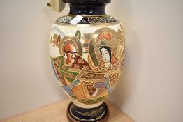 An early 20th Century Japanese Satsuma ware porcelain vase converted into a lamp base, raised on a
