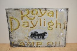 A vintage enamelled Royal Daylight Lamp Oil advertising sign, with integral pictorial cartouche