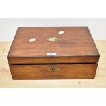 A 19th Century mahogany writing slope, having a vacant brass cartouche to the lid, opening out to