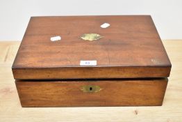 A 19th Century mahogany writing slope, having a vacant brass cartouche to the lid, opening out to