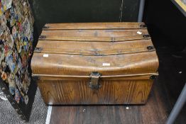 A vintage tin trunk having scumbled finish.