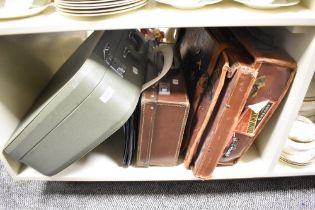 Two vintage brown leather suitcases, a leather fashion handbag, and a hardshell vintage suitcase