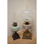 A Victorian oil lamp, having a spherical etched glass shade, a hand painted opaque glass
