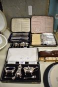 A cased Walker & Hall, Sheffield, silver plated condiment set, and three cased sets of silver plated