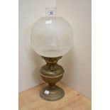 An early 20th century brass oil lamp, having frosted glass shade, approx 46cm high.