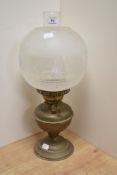 An early 20th century brass oil lamp, having frosted glass shade, approx 46cm high.