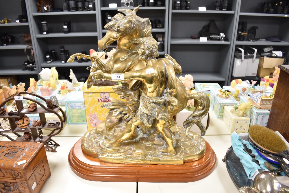 A heavy brass Marley Horse style sculpture, raised on an oval stepped mahogany plinth, altogether