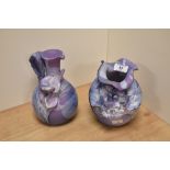 A studio pottery floral encrusted vase, of rounded form, and drip glazed on a lilac ground,