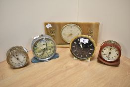 Four mid century alarm clocks and a Tempora mantel clock with celluloid surround.