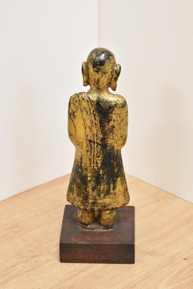 An interesting 19th Century gilt and lacquered standing Shan monk figure, holding an alms bowl, - Image 2 of 2