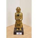 An interesting 19th Century gilt and lacquered standing Shan monk figure, holding an alms bowl,