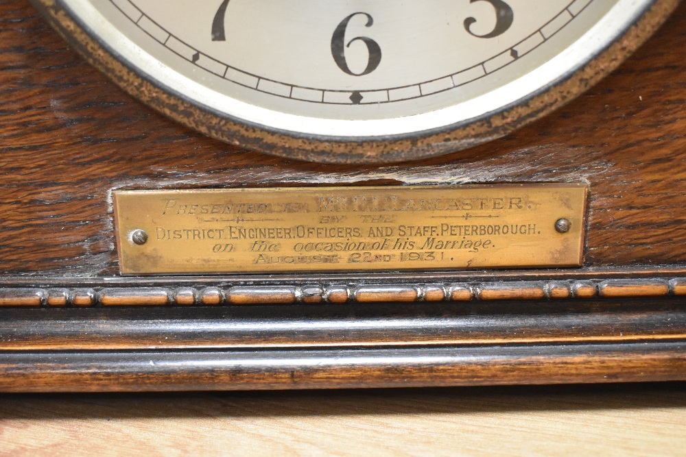 An early 20th Century oak cased mantel clock, of Napoleon's Hat shape, having a silvered arabic - Image 2 of 2