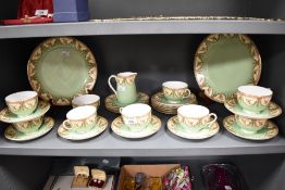 A collection of circa 1912 Royal Worcester table ware, having green and cream ground with brown swag