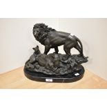 An attractive cast patinated metal lion figure group, raised upon an oval variegated marble base,