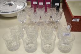 A set of eight cut glass whisky tumblers and seven cordial glasses