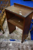 An Arts and Crafts oak bedside cabinet by Arthur Simpson handicrafts, having black and gold