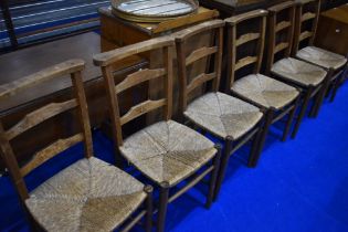 A set of six rush seated chapel chairs having ladder backs