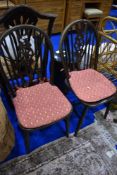 A pair of traditional wheelback kitchen chairs