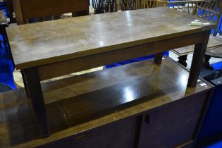 A vintage mahogany and oak coffee table having rectangular top , damaged to corner, in the Arts