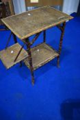A vintage bamboo table with fold down shelf to side, height approx 70cm