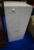 A painted bathroom or similar cabinet with drop flap doors to front and side, over double