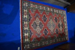 A Persian style rug, approx. 186 x 116cm, colours bit faded and tassles trimmed