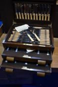 A vintage oak cased canteen containing EPNS and stainless steel cutlery, in 'Flex-Fit' racks ,