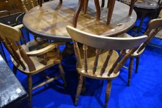 A traditional pine oval dining table on pedestal base, and six (four plus two) similar dining