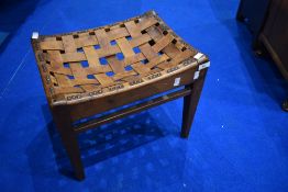An early 20th Century Arts and Crafts golden oak and latticed leather stool, in the Arthur Simpson/
