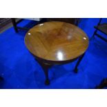 An early to mid 20th Century coffee table having circular top and cabriole legs having ball and claw