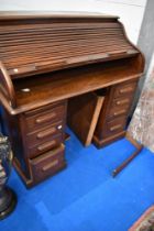 A late 19th or early 20th Century oak roll top desk having S tambour top, width approx. 127cm