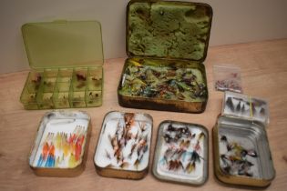 A small selection of salmon and trout flies in tins and boxes