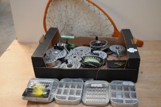 A box containing fly reels with spare spools one spinning reel a cast wallet and some Wheatley empty