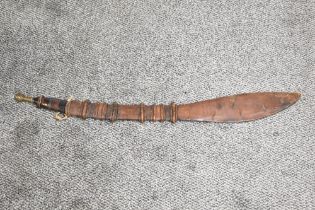 A Nigerian Takouba type Sword.leather grip with brass pommel, leather scabbard with leaf shaped