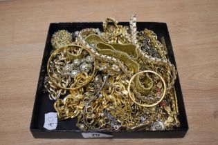An assorted collection of yellow metal and gold coloured jewellery, to include a Monet bangle,