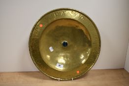 A late 19th Century hand beaten brass alms style dish, of Arts and Crafts design, with central