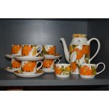 A Mid century Midwinter coffee service, having bright orange floral design on white ground,