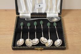 A cased set of six mid-20th Century silver plated coffee bean spoons, with green shaped finials, and
