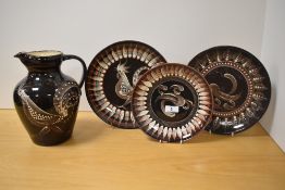 A collection of mid-20th Century Yeo studio pottery of Somerset, slip glazed against a brown ground,