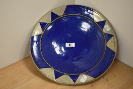 An Arts and Crafts style pottery bowl, having cobalt blue ground with white metal beading and relief