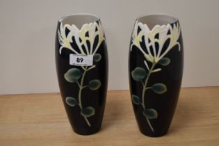 Two Franz collection porcelain vases, having honeysuckle design, AF, chip and crack to one.